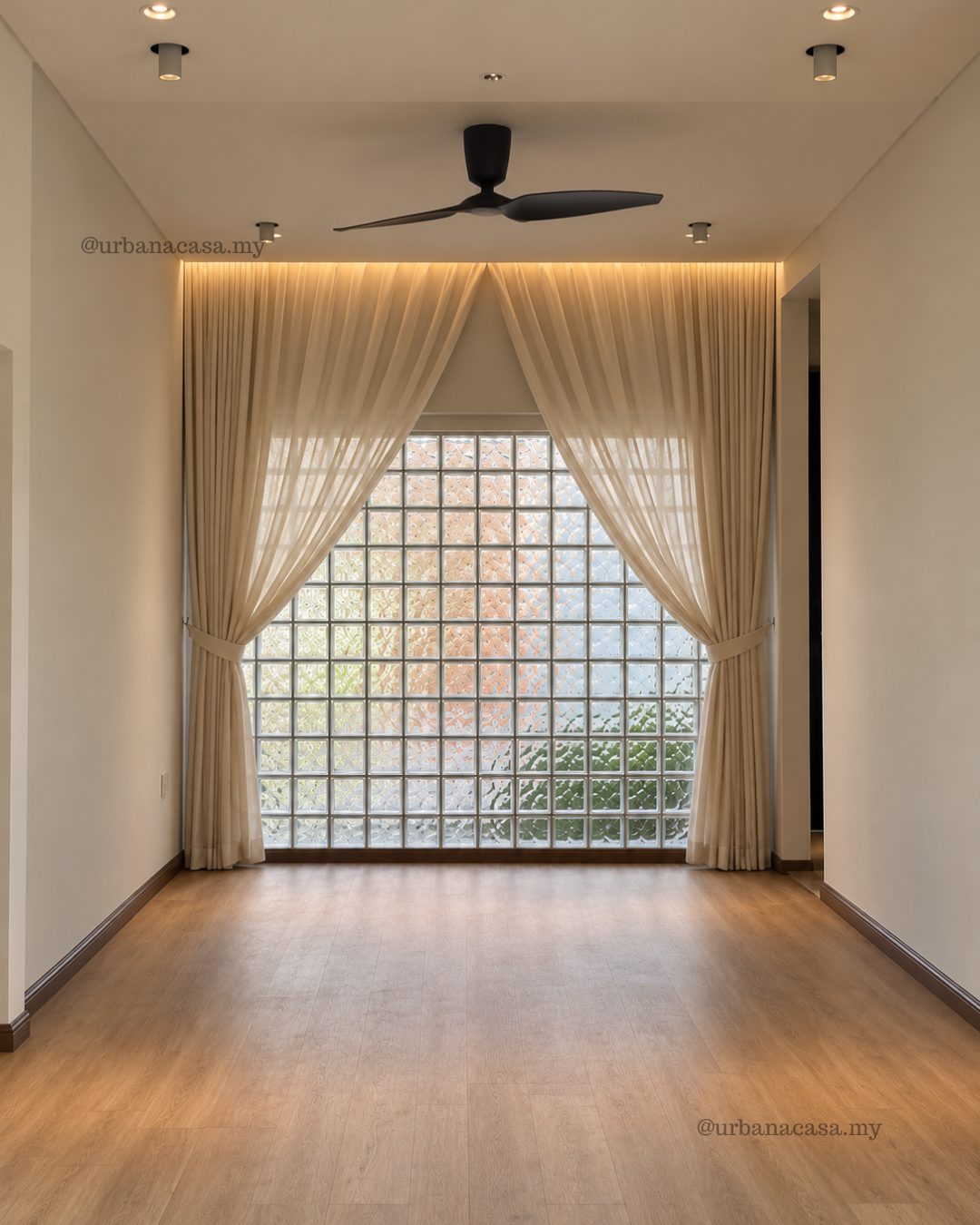 Interior design of a living area with glass block window, sheer curtains and cove lighting