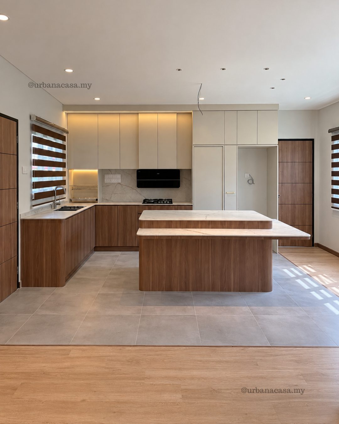 Kitchen renovation in Melaka with walnut-tone cabinets and a two-tier island